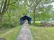A quaint blue covered bridge offers a charming way to cross the flowing creek at 315 Antebellum Way, Fayetteville, GA 30215