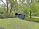 A quaint blue covered bridge offers a charming way to cross the flowing creek at 315 Antebellum Way, Fayetteville, GA 30215