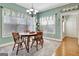 Bright dining area with wood table, chandelier, large windows, and decorative accents at 315 Antebellum Way, Fayetteville, GA 30215