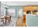Eat-in kitchen dining area features a wood table, decorative lighting and window, and a pass-through to kitchen at 315 Antebellum Way, Fayetteville, GA 30215