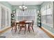 Cozy dining area features a wood table, decorative shelves, and large windows for plenty of natural light at 315 Antebellum Way, Fayetteville, GA 30215