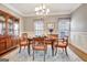 Inviting dining room with hardwood floors, chandelier, and custom hutch perfect for entertaining and Gathering dinners at 315 Antebellum Way, Fayetteville, GA 30215