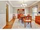 Elegant dining room with chandelier, wooden table, and hutch creating a perfect setting for gatherings at 315 Antebellum Way, Fayetteville, GA 30215