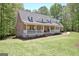 Charming brick home featuring a welcoming front porch and well-manicured lawn at 315 Antebellum Way, Fayetteville, GA 30215