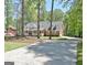 Traditional brick home featuring mature trees and a long driveway at 315 Antebellum Way, Fayetteville, GA 30215