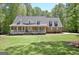 Inviting brick home featuring a charming front porch and lush green lawn at 315 Antebellum Way, Fayetteville, GA 30215