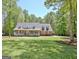 Traditional brick home with a sprawling front yard and a welcoming front porch at 315 Antebellum Way, Fayetteville, GA 30215