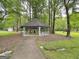 A charming gazebo offers a shady spot to relax and unwind in a peaceful, wooded setting at 315 Antebellum Way, Fayetteville, GA 30215