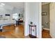 Hallway view leading to a charming powder room and the main living area with hardwood floors and neutral paint at 315 Antebellum Way, Fayetteville, GA 30215