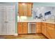 Modern kitchen with stainless steel appliances, light wood cabinets and access to dining area at 315 Antebellum Way, Fayetteville, GA 30215