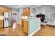 Modern kitchen with stainless steel appliances, hardwood floors, a breakfast bar, and a view to the living area at 315 Antebellum Way, Fayetteville, GA 30215