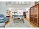 Open living room with a beautiful sofa set, wood floors, an area rug, and natural light from the front entry at 315 Antebellum Way, Fayetteville, GA 30215