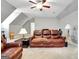 Spacious living room is accentuated by a leather sofa, ceiling fan, and neutral color scheme at 315 Antebellum Way, Fayetteville, GA 30215
