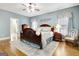Tranquil main bedroom features a ceiling fan, hardwood floors, and natural light through the windows at 315 Antebellum Way, Fayetteville, GA 30215