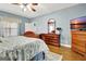Bright main bedroom with natural light, hardwood floors, and a view of the dresser and TV at 315 Antebellum Way, Fayetteville, GA 30215