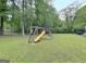 A wooden playground is great for the children to enjoy on the lush green lawn at 315 Antebellum Way, Fayetteville, GA 30215