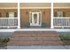 Inviting front porch with brick steps, decorative planters, and classic details at 315 Antebellum Way, Fayetteville, GA 30215