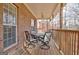 Covered porch with brick exterior and table and chairs at 315 Antebellum Way, Fayetteville, GA 30215