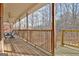 View of the covered porch and wooded area at 315 Antebellum Way, Fayetteville, GA 30215
