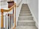 Carpeted staircase with white and wooden railing leads to the upper level at 315 Antebellum Way, Fayetteville, GA 30215