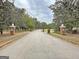 Street view of a neighborhood entrance featuring tree-lined street and brick pillars at 315 Antebellum Way, Fayetteville, GA 30215