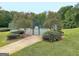 A lovely tennis court sits nestled among shade trees and well-manicured landscaping at 315 Antebellum Way, Fayetteville, GA 30215