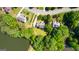 Aerial view of the home surrounded by lush greenery and a lake, with the driveway visible at 255 Hidden Lake Dr, Fayetteville, GA 30215