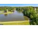 Scenic lake view featuring a fountain, green space, and a dock, offering a serene community setting at 255 Hidden Lake Dr, Fayetteville, GA 30215