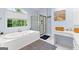 Bright bathroom features a soaking tub, walk-in shower, and decorative rug at 255 Hidden Lake Dr, Fayetteville, GA 30215