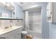 Bathroom features a white vanity with a mirror, a toilet, and a shower/tub combination with a white shower curtain at 255 Hidden Lake Dr, Fayetteville, GA 30215