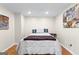Bedroom featuring a queen bed with decorative pillows and a duvet, with minimal decoration and hardwood floors at 255 Hidden Lake Dr, Fayetteville, GA 30215