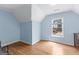 Bright bedroom with hardwood floors and a large window overlooking the front yard at 255 Hidden Lake Dr, Fayetteville, GA 30215