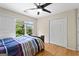 Bedroom has hardwood floors and a closet with louvered doors at 255 Hidden Lake Dr, Fayetteville, GA 30215