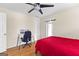 Functional bedroom setup featuring hardwood floors, a study desk, and a comfortable bed, ideal for work or relaxation at 255 Hidden Lake Dr, Fayetteville, GA 30215