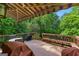 Cozy wooden deck with shaded awning, surrounded by lush trees, and furnished with an outdoor dining area at 255 Hidden Lake Dr, Fayetteville, GA 30215
