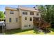Exterior of the home with a wooden deck and stairs leading to the landscaped back yard at 255 Hidden Lake Dr, Fayetteville, GA 30215