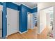 Hallway with hardwood floors showing pantry and open doorways at 255 Hidden Lake Dr, Fayetteville, GA 30215