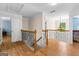 Second-floor hallway features hardwood floors, iron railing, and elegant trimwork in this home at 255 Hidden Lake Dr, Fayetteville, GA 30215