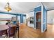 Open floor plan of kitchen features white cabinets, hardwood floors, stainless steel appliances and dining area at 255 Hidden Lake Dr, Fayetteville, GA 30215