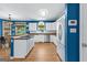 Bright kitchen with granite counters, hardwood floors, stainless steel appliances, white cabinets, and a gas range at 255 Hidden Lake Dr, Fayetteville, GA 30215