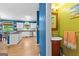 View of modern kitchen with white cabinetry and half bath with quirky, colorful design in this home at 255 Hidden Lake Dr, Fayetteville, GA 30215