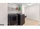 Well-equipped laundry area with sleek, dark gray modern appliances, efficient shelving, and a utility sink, ensuring functionality at 255 Hidden Lake Dr, Fayetteville, GA 30215