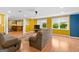 Expansive living room featuring an open layout, bright yellow walls, and comfortable seating, perfect for relaxation and entertainment at 255 Hidden Lake Dr, Fayetteville, GA 30215