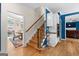 View of oak staircase leading to the second level and eat-in area with gorgeous natural light at 255 Hidden Lake Dr, Fayetteville, GA 30215