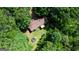 Aerial view showcasing a home with mature landscaping, a hot tub and a deck at 1638 River Trc, Auburn, GA 30011