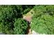 Aerial view of a home with mature trees, trampoline and a deck for outdoor enjoyment at 1638 River Trc, Auburn, GA 30011