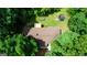 Aerial view showcasing a home with a deck, patio, and a trampoline surrounded by trees at 1638 River Trc, Auburn, GA 30011
