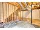 Unfinished basement with visible wooden beams, wall studs, and a concrete floor at 1638 River Trc, Auburn, GA 30011