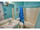 This small bathroom features a blue shower curtain, seashell decorations and an integrated sink and vanity at 1638 River Trc, Auburn, GA 30011