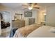 Spacious bedroom featuring an ensuite bathroom, ceiling fan, and tv at 1638 River Trc, Auburn, GA 30011